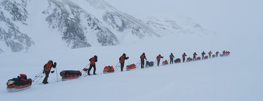 Expedition hiking in Svalbard, snowy landscape with feeling of danger